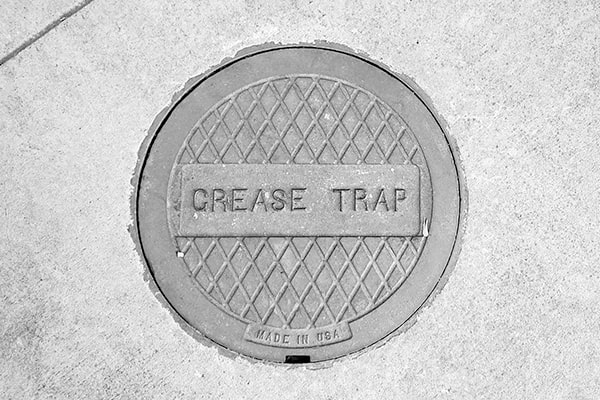 foul odors, slow drainage, or grease overflowing from the trap are signs that your grease trap may need pumping